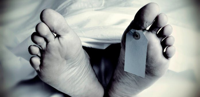 dead body with a blank toe tag, in monochrome