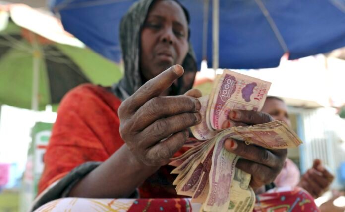 A money changer counts local currency notes at a local bureau where $100 US dollar exchanges for 750,000 Somaliland shillings in Hargeysa