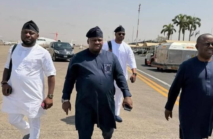 Senator of Taraba South, David Jimkuta (middle) at Abuja Airport