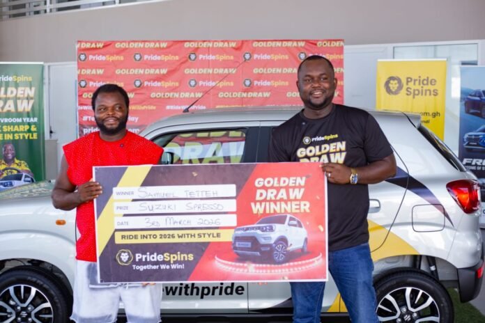 Samuel Tetteh (left) receiving his car key from Kwadwo Opoku Kwarteng Amaning (right)
