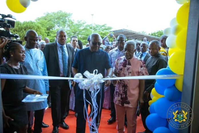 John Dramani Mahama cutting tape to mark the official opening of the PET Scan facility