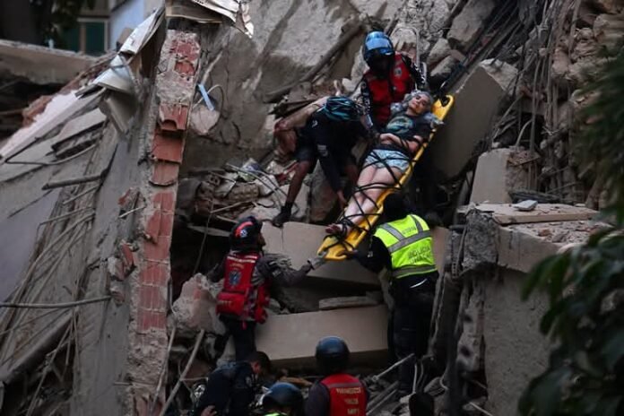 A woman being rescued following the twin quakes in Venezuela