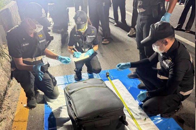 Thai police with the suitcase in which the 17-year-old girl's naked body was found