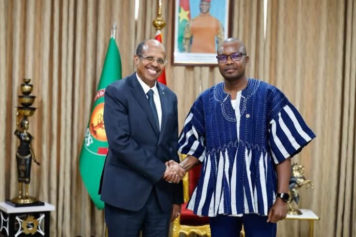 Mahmoud Ali Youssouf (left) in a handshake with Rimtalba Jean Emmanuel Ouédraogo in Ouagadougou, Burkina Faso