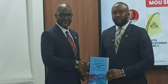 Dzifa Gunu (left) and Malik Basintale (right) displaying the MoU after its signing Dzifa Gunu (left) and Malik Basintale (right) displaying the MoU after its signing