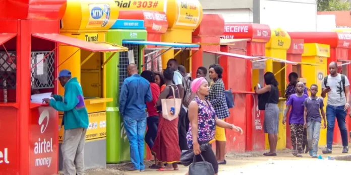 Ghanaians at mobile money booths