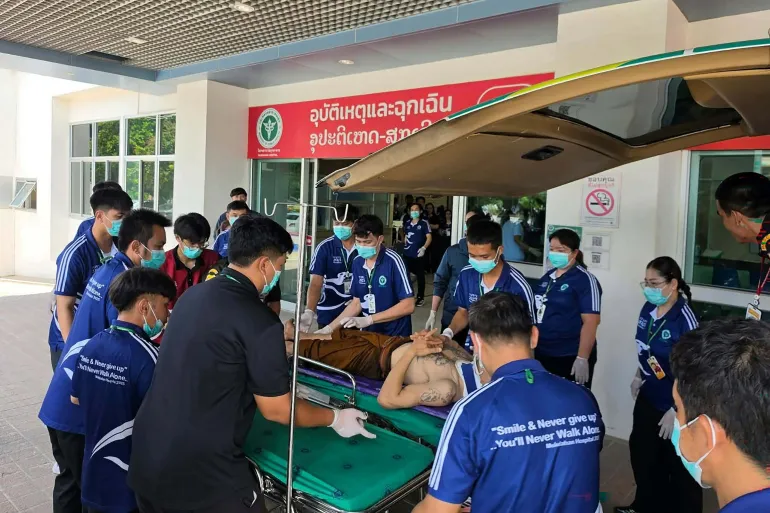 A handout photo by Ruamjai Mukdahan Rescue Foundation shows an injured monk arriving at Mukdahan Hospital after a collision between a pick-up truck driven by an 11-year-old and a procession of Buddhist monks [Handout/Ruamjai Mukdahan Rescue Foundation via AFP]