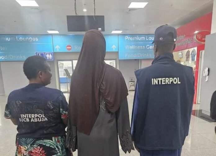 Mahadijiria Abdoulaye (middle) was arrested by INTERPOL in Nigeria 