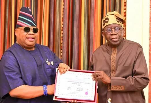 Ademola Adeleke (left) presenting his certificate of return to President Bola Ahmed Tinubu