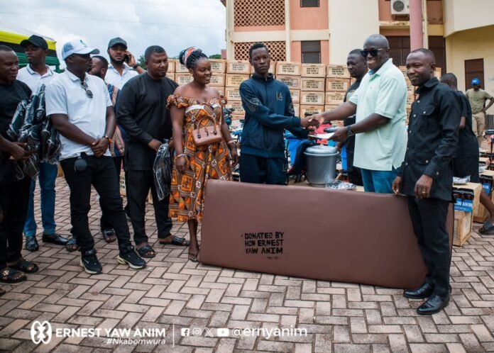Ernest Yaw Anim (right) making a presentation to one of the students