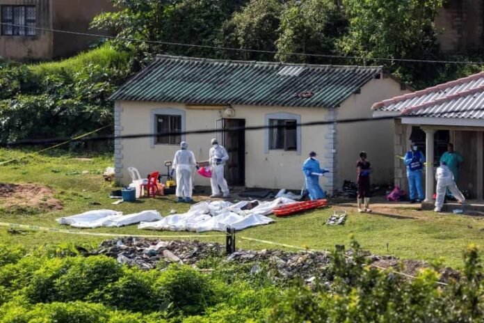 Police forensics personnel work at the scene a shooting in the township of KwaMakhutha near Durban, South Africa [Reuters]